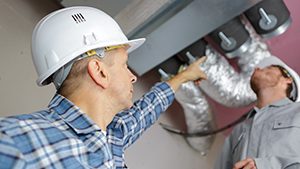 AC Air Duct Cleaner inspecting ducts