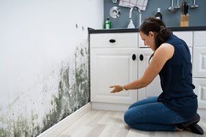 Woman noticing mold in her kitchen
