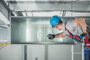 commercial air duct being cleaning by professional
