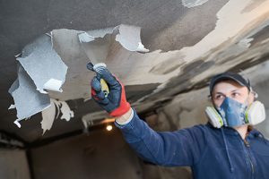 Specialist cleans ceiling smoke, a type of fire damage